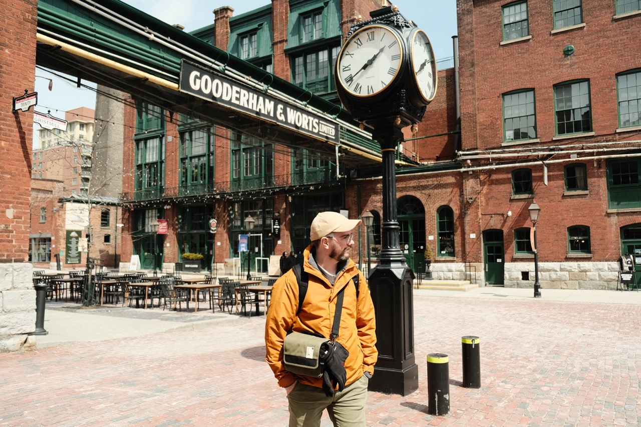 Rob in Toronto's Distillery District, standing by the Gooderham & Worts clock